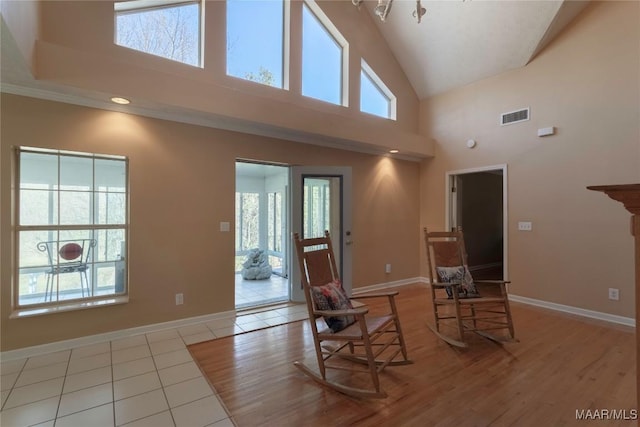 living area featuring a wealth of natural light, visible vents, and baseboards