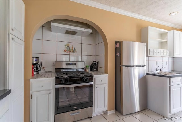 kitchen with extractor fan, white cabinets, appliances with stainless steel finishes, backsplash, and open shelves