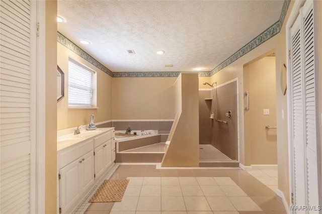 bathroom with a closet, a tile shower, a textured ceiling, tile patterned flooring, and a bath