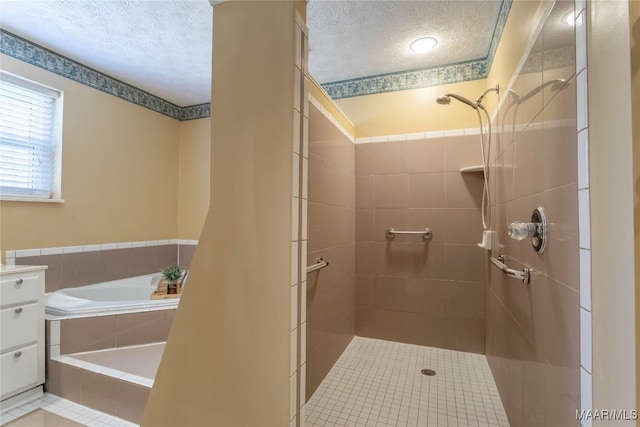 full bathroom with a bath, a shower stall, and a textured ceiling