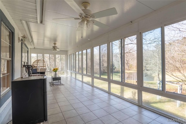 unfurnished sunroom with a ceiling fan