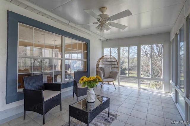 sunroom with a wealth of natural light and a ceiling fan