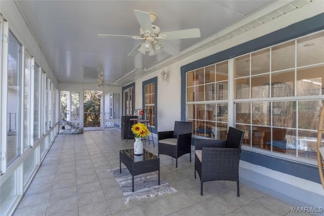 unfurnished sunroom with ceiling fan