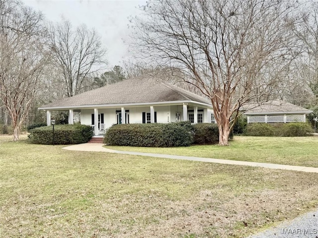 ranch-style house featuring a porch, roof with shingles, and a front yard