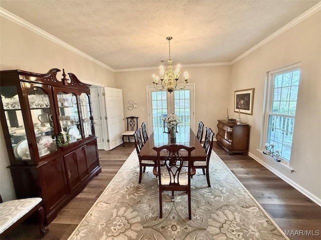 dining room with a textured ceiling, dark wood-type flooring, a chandelier, and a wealth of natural light