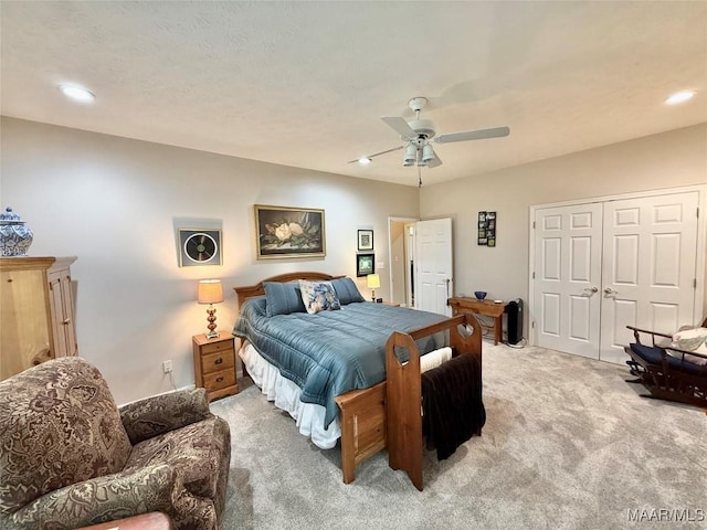 bedroom featuring recessed lighting, a closet, light carpet, and ceiling fan