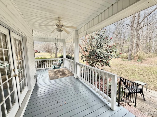 wooden terrace featuring french doors and a ceiling fan