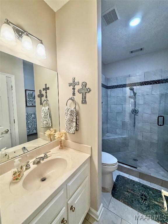 bathroom with visible vents, toilet, a stall shower, a textured ceiling, and tile patterned flooring