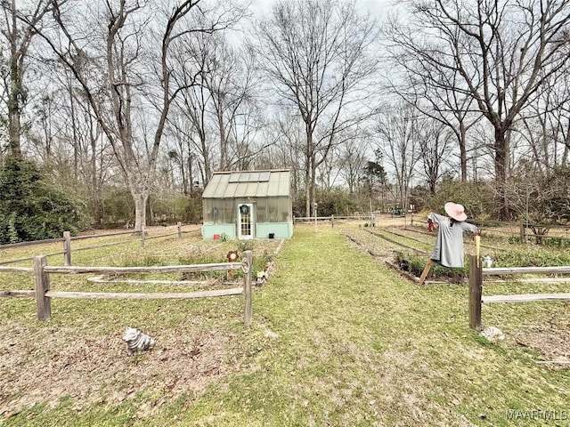 view of yard featuring an outbuilding, an exterior structure, and fence