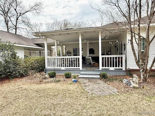 rear view of house featuring covered porch