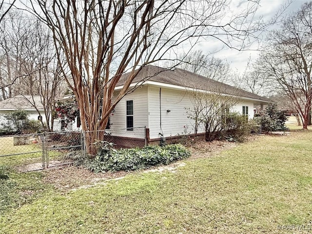 view of property exterior featuring fence and a lawn