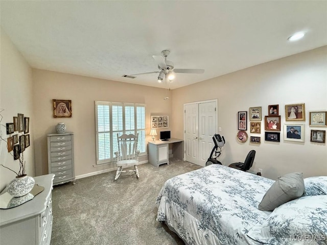 carpeted bedroom with a ceiling fan, a closet, visible vents, and baseboards