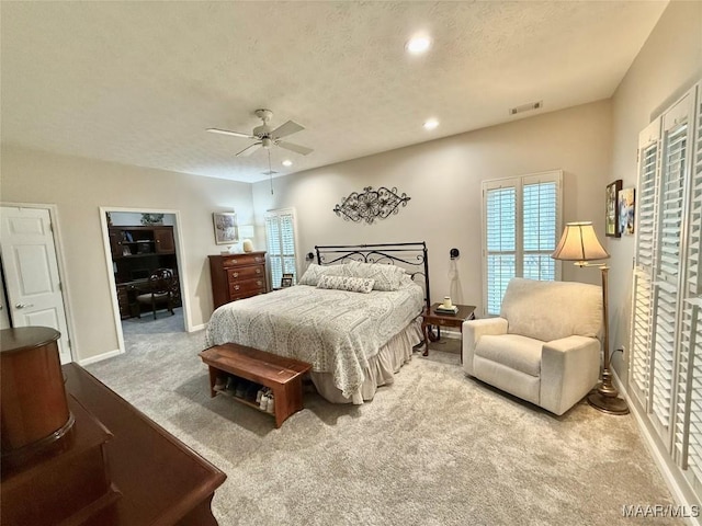 bedroom with a textured ceiling, recessed lighting, visible vents, baseboards, and carpet