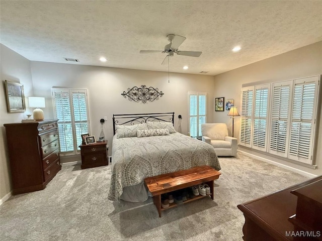 bedroom with a textured ceiling, visible vents, carpet flooring, and recessed lighting