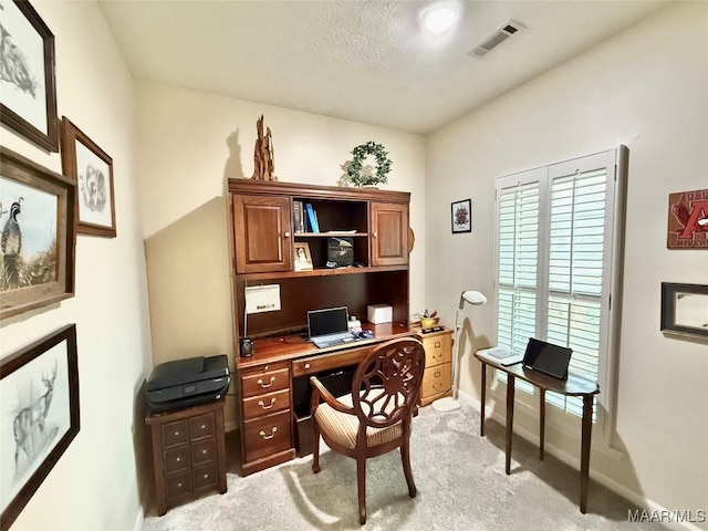 office space with light carpet, baseboards, and visible vents