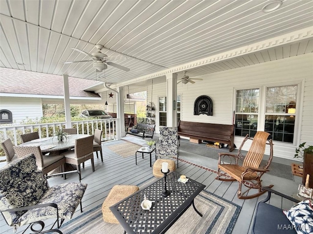 wooden deck with ceiling fan and outdoor dining area