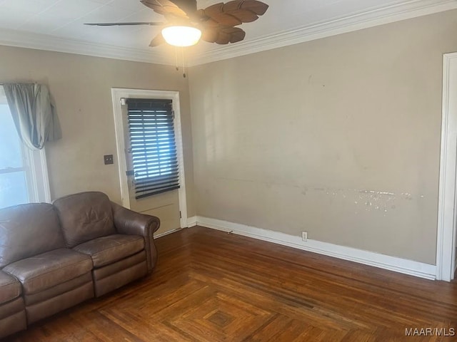 living area with ornamental molding, ceiling fan, and baseboards