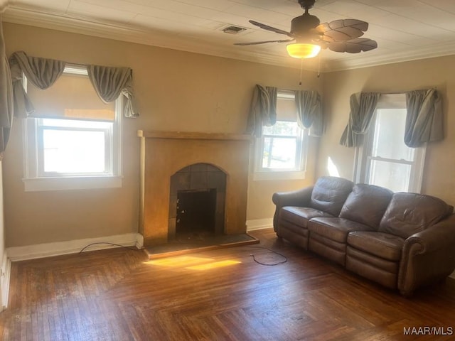 living room featuring a fireplace, a ceiling fan, visible vents, baseboards, and ornamental molding