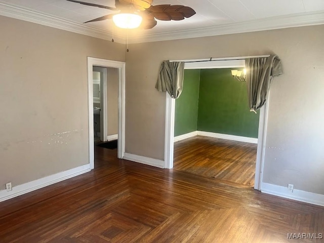 empty room with ceiling fan, baseboards, and crown molding