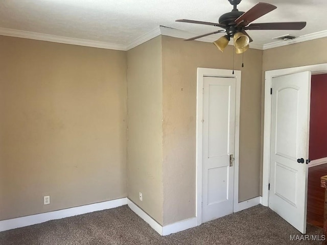 unfurnished bedroom with visible vents, baseboards, a ceiling fan, carpet, and crown molding