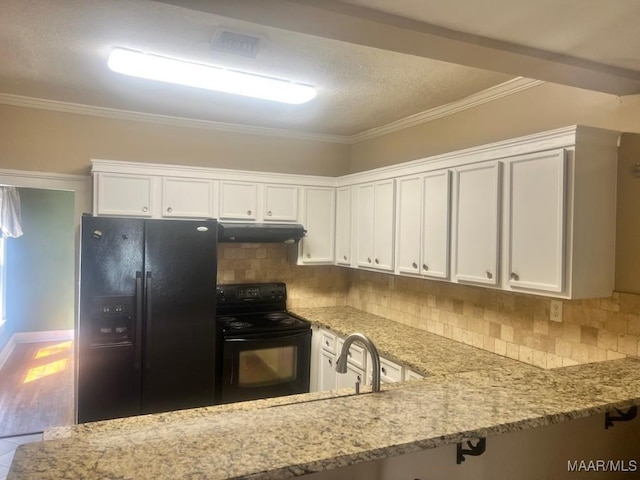 kitchen featuring decorative backsplash, light stone countertops, under cabinet range hood, black appliances, and white cabinetry