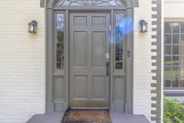 property entrance with brick siding