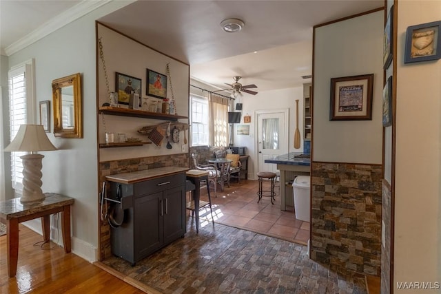 interior space with baseboards and ornamental molding