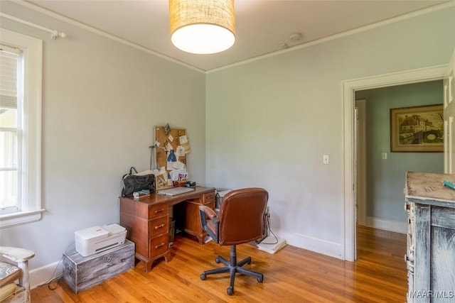 office area featuring ornamental molding, light wood-type flooring, and baseboards