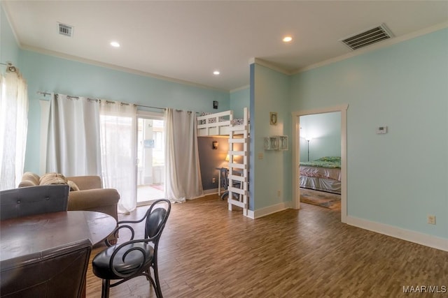 office area featuring ornamental molding, wood finished floors, visible vents, and baseboards