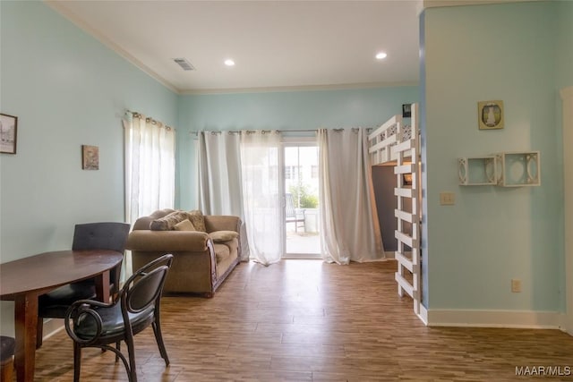 living area featuring ornamental molding, wood finished floors, visible vents, and recessed lighting