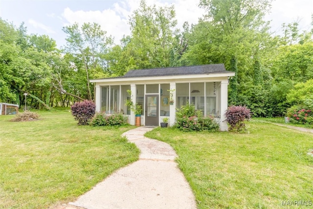 view of front of house featuring a front lawn and a sunroom