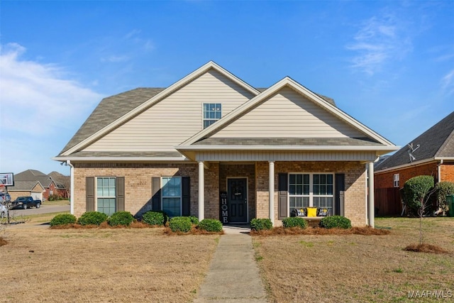 view of front facade featuring a porch and brick siding