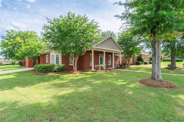 view of front of property with a front yard and brick siding