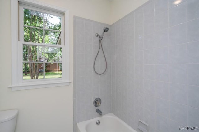 bathroom with tub / shower combination and toilet