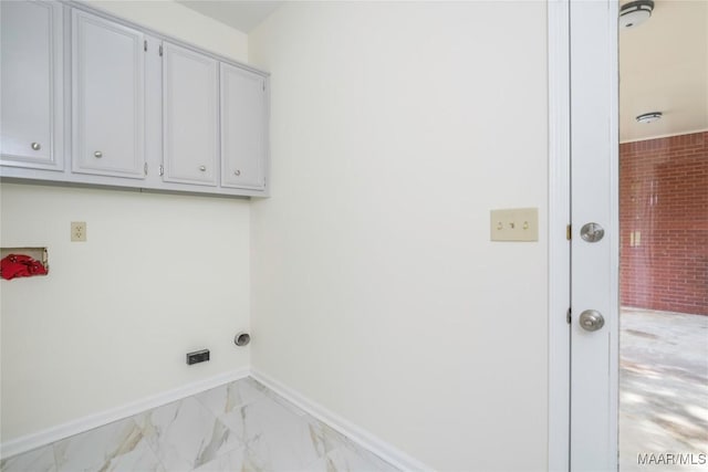 laundry area featuring marble finish floor and baseboards