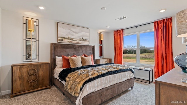 carpeted bedroom featuring recessed lighting, visible vents, and baseboards