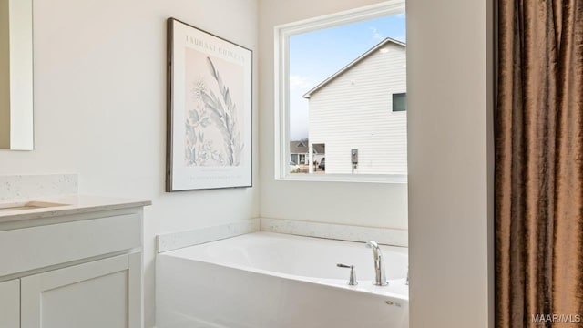 full bathroom featuring a bath and vanity