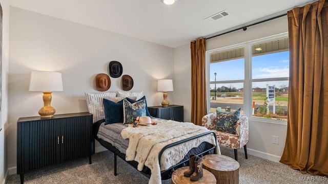 bedroom with multiple windows, carpet flooring, visible vents, and baseboards