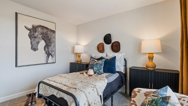 carpeted bedroom featuring baseboards