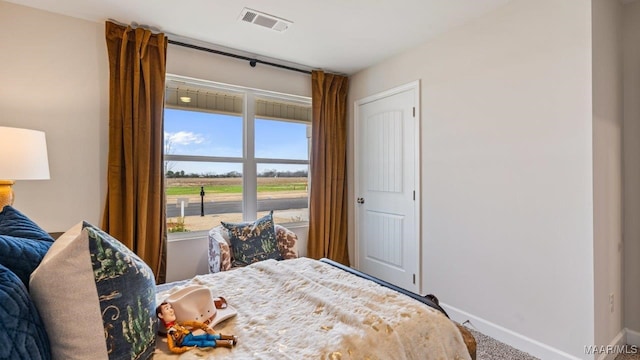 bedroom featuring visible vents and baseboards