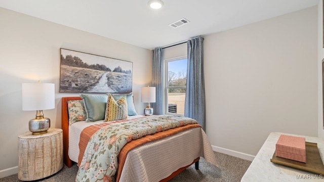 bedroom with carpet floors, visible vents, and baseboards