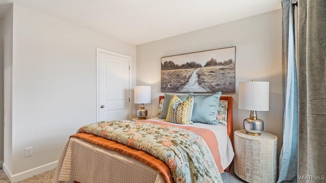 bedroom with carpet floors and baseboards