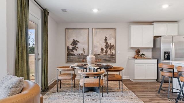 dining space featuring dark wood-style floors, baseboards, visible vents, and recessed lighting