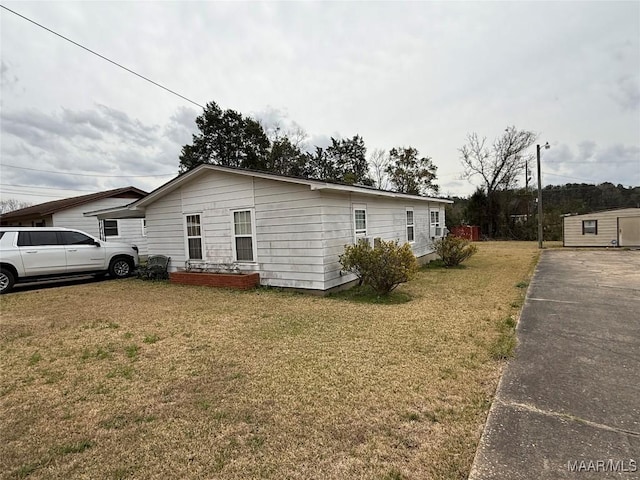 view of side of property with a lawn