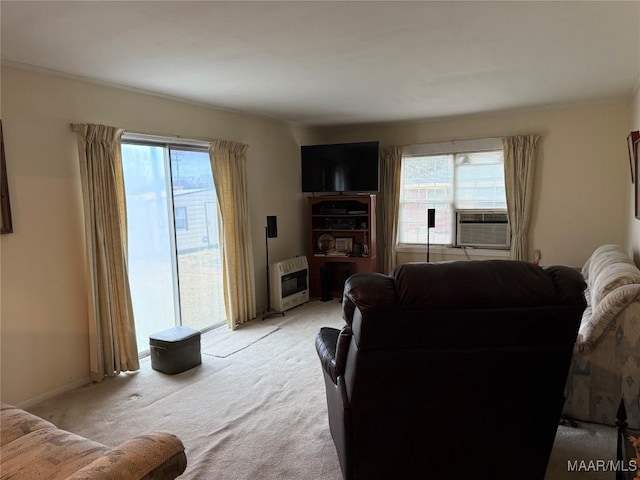 living room featuring plenty of natural light, cooling unit, light colored carpet, and heating unit