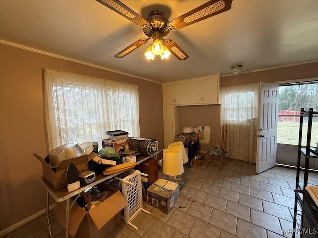 interior space with light tile patterned floors, a ceiling fan, white cabinetry, and crown molding