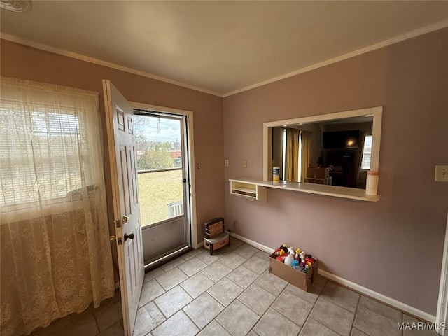 doorway featuring light tile patterned floors, baseboards, and ornamental molding