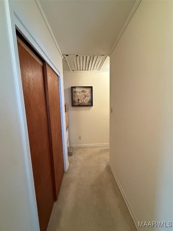 hall with ornamental molding and baseboards