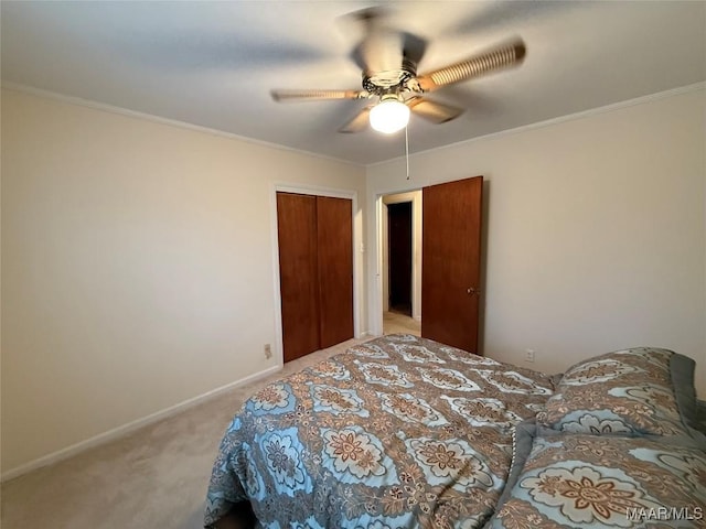 bedroom featuring a closet, ornamental molding, a ceiling fan, light carpet, and baseboards