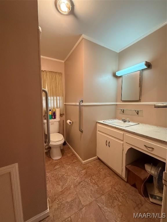 bathroom with ornamental molding, baseboards, vanity, and toilet